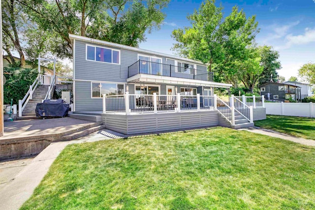 back of house with a wooden deck and a yard