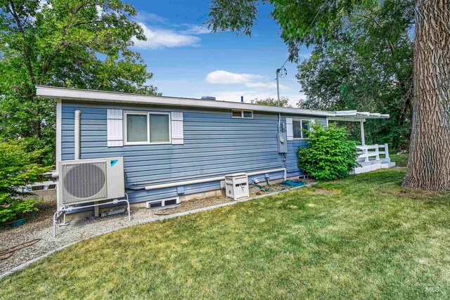 back of house with a lawn and ac unit