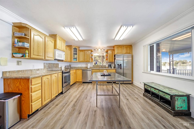 kitchen featuring light hardwood / wood-style flooring, stainless steel appliances, light stone countertops, and crown molding