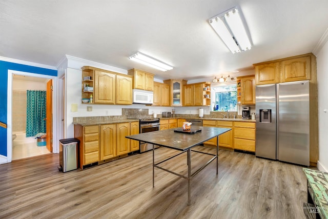 kitchen featuring light hardwood / wood-style flooring, stainless steel appliances, sink, and crown molding