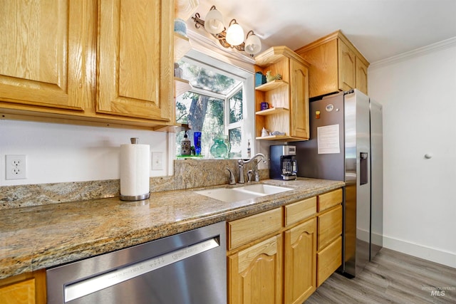 kitchen with light stone counters, light hardwood / wood-style floors, sink, appliances with stainless steel finishes, and crown molding