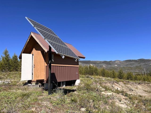 532 Warren Creek Rd, Warren, ID 83671 - view of side of property with a metal roof, an outdoor structure, and a mountain view