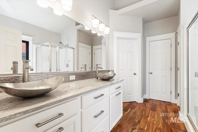 2249 N Eagle Creek Ln, Eagle, ID 83616 - full bathroom featuring a shower stall, double vanity, and wood finished floors