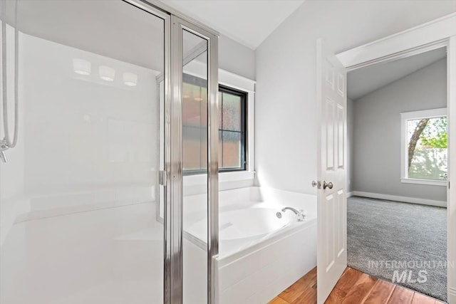 2249 N Eagle Creek Ln, Eagle, ID 83616 - bathroom featuring lofted ceiling, a shower stall, a bath, and wood finished floors