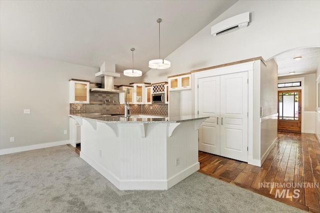 2249 N Eagle Creek Ln, Eagle, ID 83616 - kitchen with stainless steel microwave, glass insert cabinets, stone counters, arched walkways, and a wall unit AC