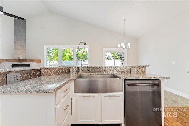 2249 N Eagle Creek Ln, Eagle, ID 83616 - kitchen with dishwasher, lofted ceiling, healthy amount of natural light, light stone counters, and white cabinets
