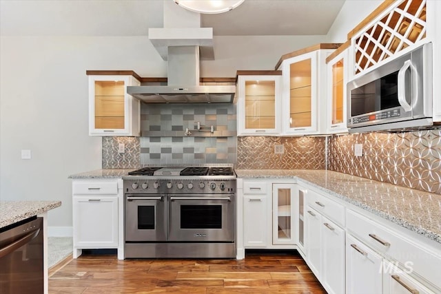 2249 N Eagle Creek Ln, Eagle, ID 83616 - kitchen featuring stainless steel appliances, wall chimney exhaust hood, light wood-style flooring, and white cabinets