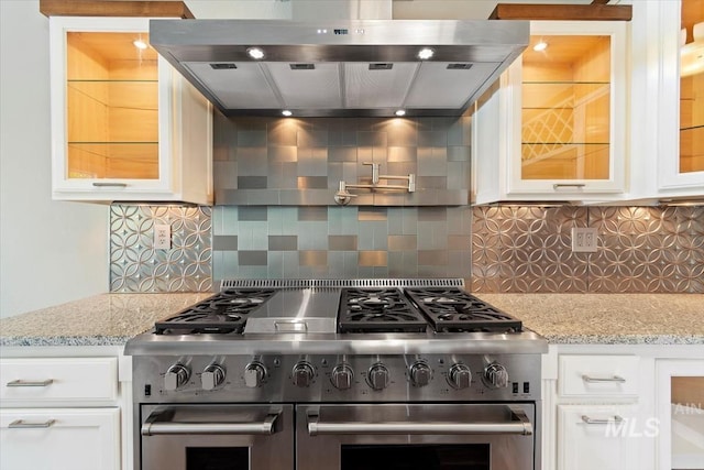 2249 N Eagle Creek Ln, Eagle, ID 83616 - kitchen with double oven range, wall chimney exhaust hood, white cabinetry, and glass insert cabinets