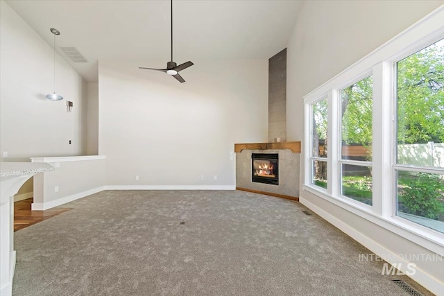2249 N Eagle Creek Ln, Eagle, ID 83616 - unfurnished living room with a fireplace, carpet floors, ceiling fan, baseboards, and high vaulted ceiling