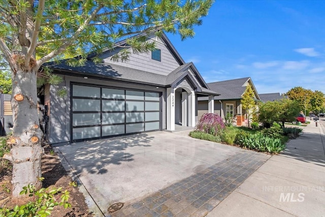 2249 N Eagle Creek Ln, Eagle, ID 83616 - view of front of home featuring concrete driveway, an attached garage, and roof with shingles