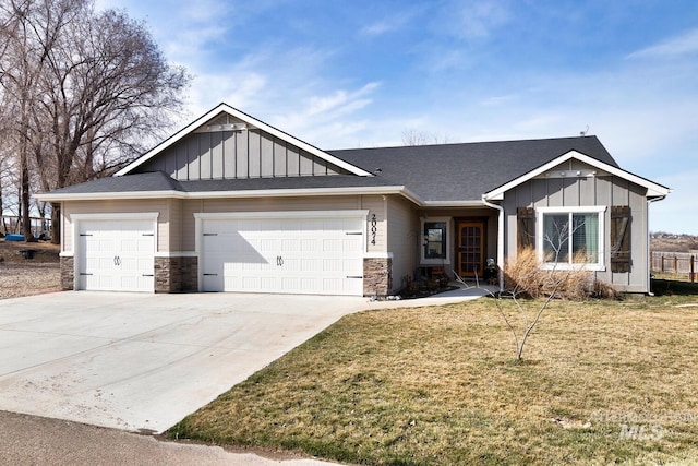 view of front of property featuring driveway, a front lawn, stone siding, a garage, and board and batten siding