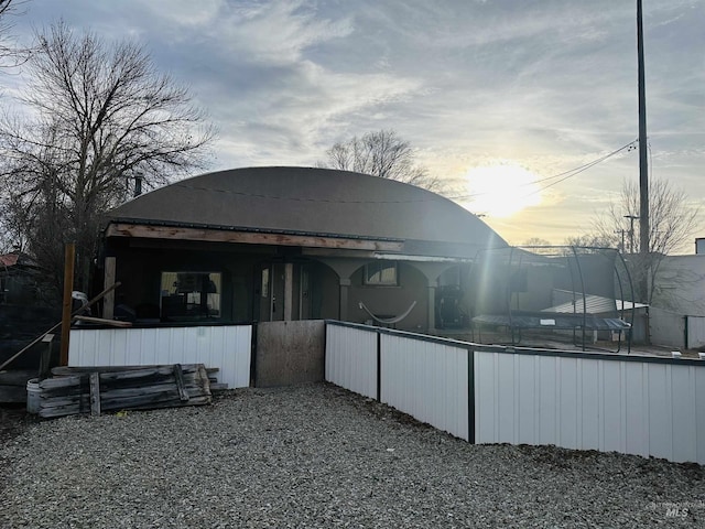 view of back house at dusk