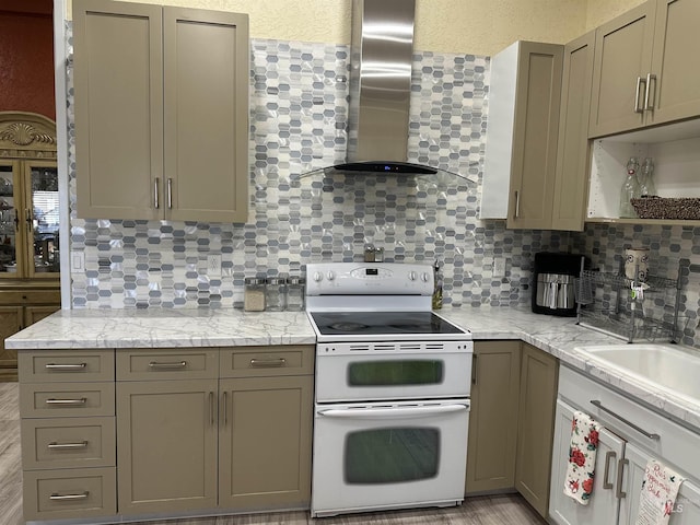 kitchen with light stone countertops, decorative backsplash, exhaust hood, and white electric range