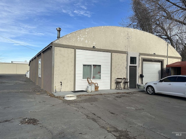 rear view of house featuring a garage