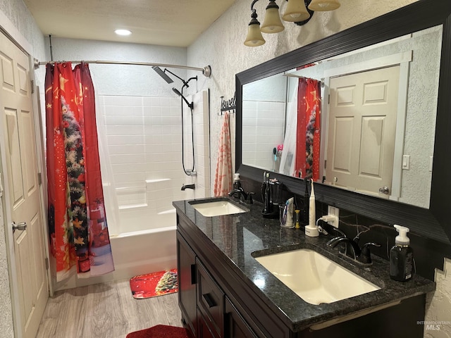 bathroom with wood-type flooring, vanity, and shower / bathtub combination with curtain