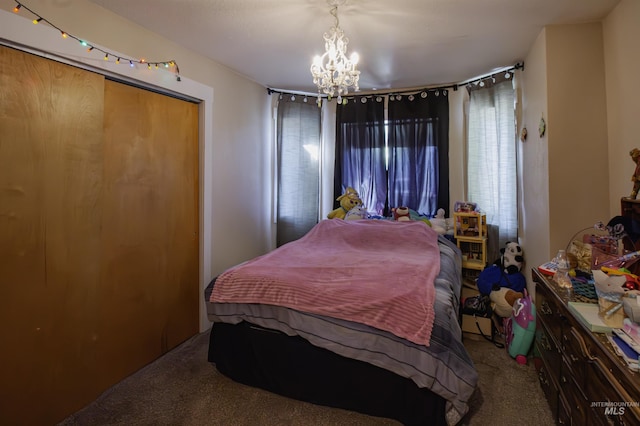 bedroom with carpet floors, a notable chandelier, and a closet