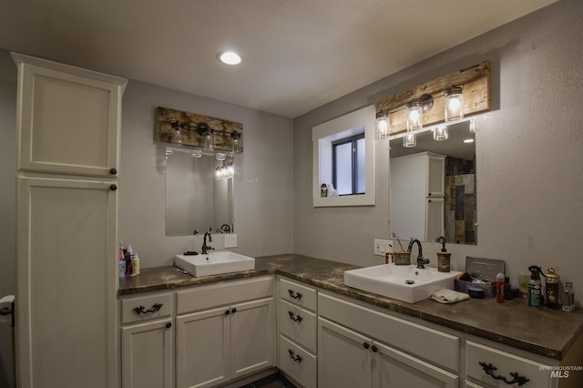 bathroom with double vanity, recessed lighting, and a sink