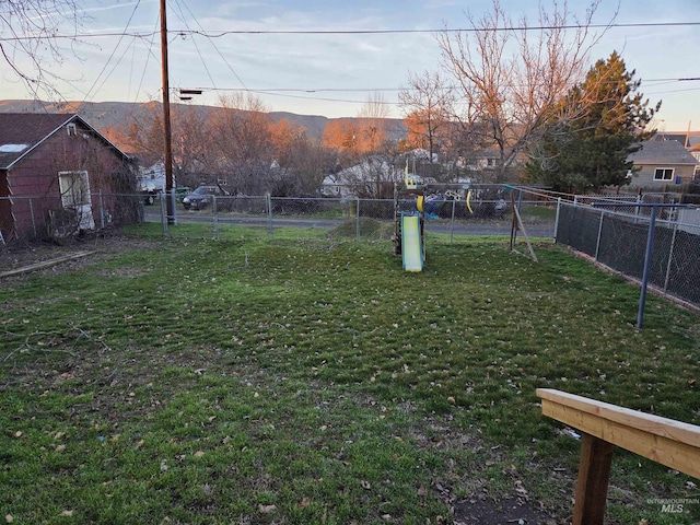 view of yard with a fenced backyard and a mountain view