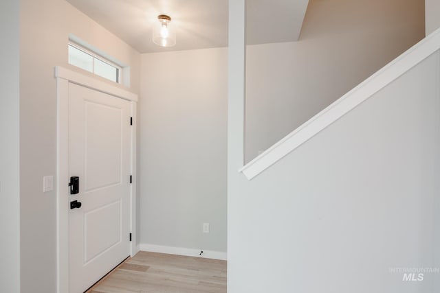 entryway featuring baseboards and light wood-style floors