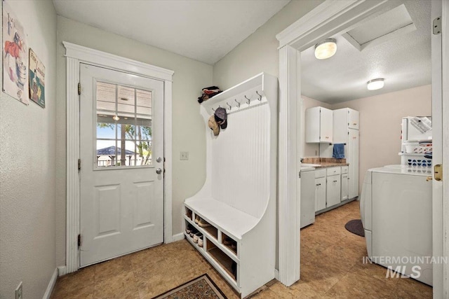 7425 Robinson Rd, Kuna, ID 83634 - mudroom with attic access, washer / clothes dryer, and light flooring