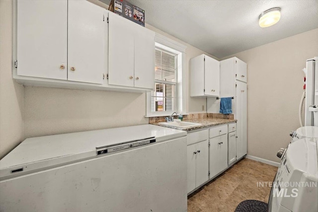 7425 Robinson Rd, Kuna, ID 83634 - kitchen with white cabinets, light countertops, and freestanding refrigerator