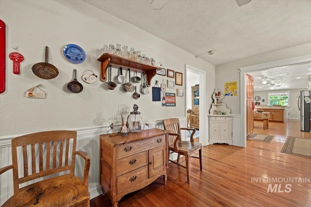 7425 Robinson Rd, Kuna, ID 83634 - sitting room with a textured ceiling, wood finished floors, and wainscoting
