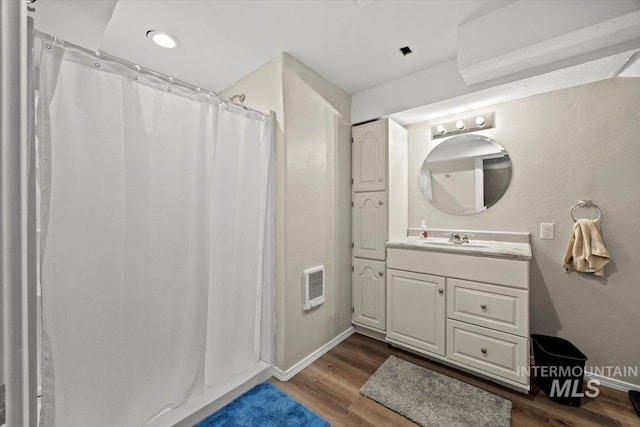 7425 Robinson Rd, Kuna, ID 83634 - full bathroom with heating unit, wood finished floors, vanity, and curtained shower