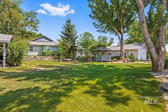 7425 Robinson Rd, Kuna, ID 83634 - view of green lawn with a gazebo and a wooden deck