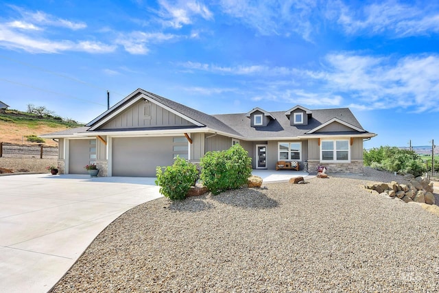 3225 Purdom Ln, Homedale, ID 83628 - view of front facade featuring stone siding, a garage, board and batten siding, concrete driveway, and roof with shingles