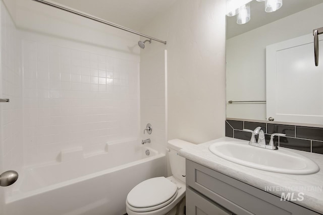 full bathroom with tasteful backsplash, shower / bath combination, vanity, and toilet