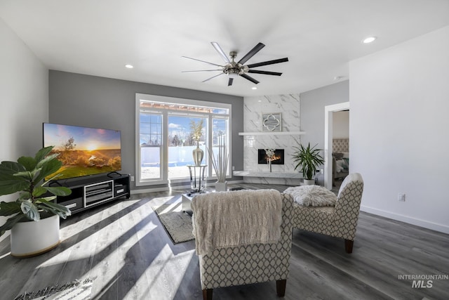 922 Victory Dr, Gooding, ID 83330 - living room featuring wood finished floors, a ceiling fan, baseboards, a fireplace, and recessed lighting