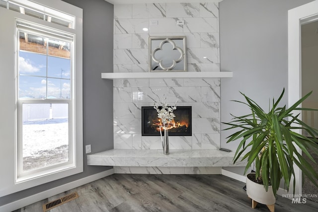 922 Victory Dr, Gooding, ID 83330 - room details with a premium fireplace, visible vents, baseboards, and wood finished floors