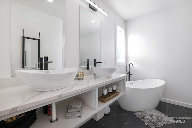 922 Victory Dr, Gooding, ID 83330 - full bathroom with double vanity, recessed lighting, a freestanding bath, and a sink
