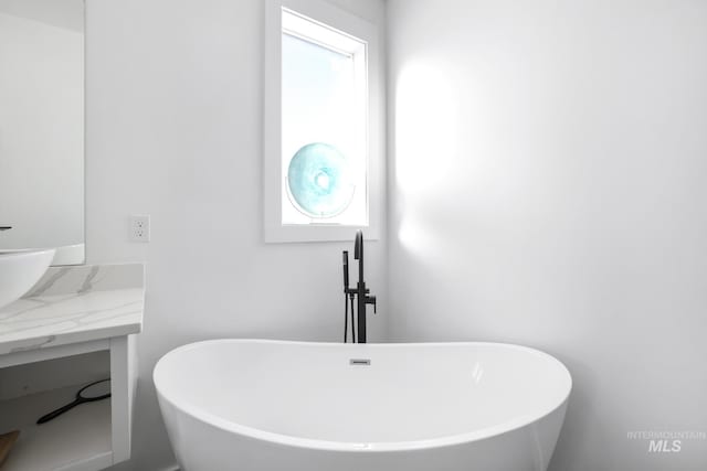 922 Victory Dr, Gooding, ID 83330 - full bathroom with a wealth of natural light, a freestanding tub, and vanity