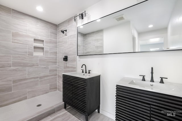 922 Victory Dr, Gooding, ID 83330 - bathroom with two vanities, walk in shower, visible vents, and a sink