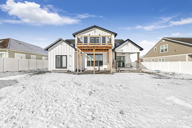922 Victory Dr, Gooding, ID 83330 - snow covered back of property with board and batten siding and a fenced backyard