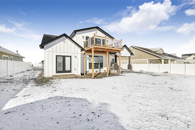 922 Victory Dr, Gooding, ID 83330 - snow covered rear of property with a fenced backyard and board and batten siding