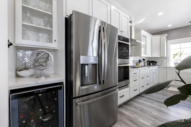 922 Victory Dr, Gooding, ID 83330 - kitchen featuring glass insert cabinets, appliances with stainless steel finishes, beverage cooler, and white cabinets