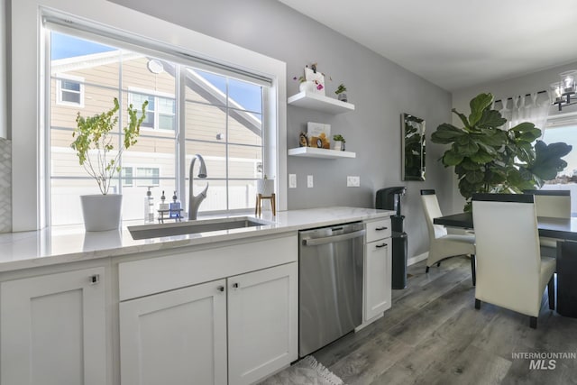 922 Victory Dr, Gooding, ID 83330 - kitchen with a sink, light stone counters, stainless steel dishwasher, wood finished floors, and white cabinetry