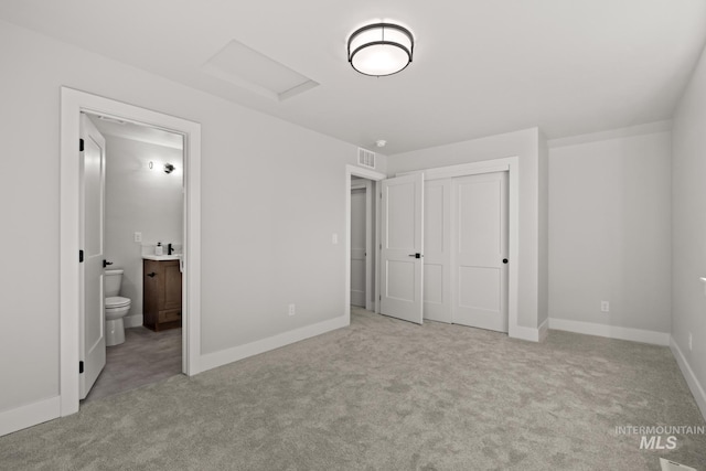 6920 N Spencer Way, Meridian, ID 83646 - unfurnished bedroom with attic access, carpet, ensuite bath, baseboards, and a closet