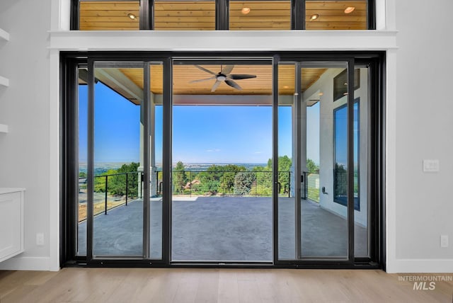 doorway to outside with ceiling fan and light hardwood / wood-style floors