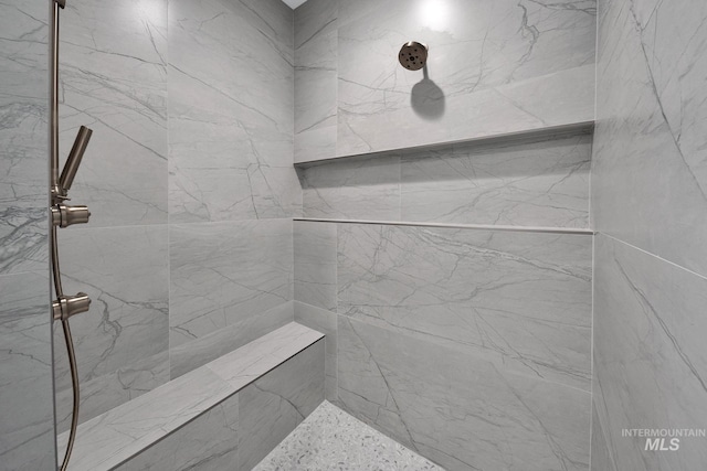 bathroom with tiled shower