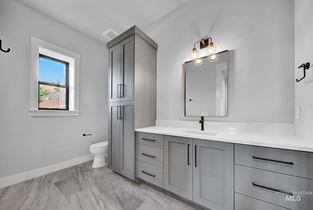 bathroom featuring toilet and vanity