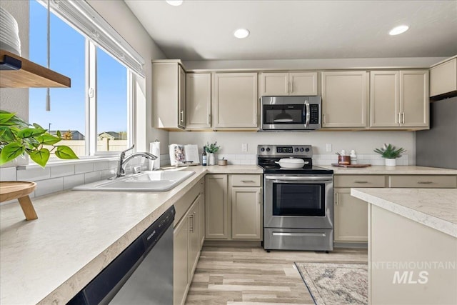 4447 W Everest St, Meridian, ID 83646 - kitchen featuring a sink, light wood finished floors, light countertops, stainless steel appliances, and recessed lighting