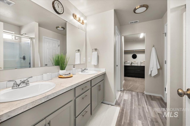 4447 W Everest St, Meridian, ID 83646 - full bathroom with visible vents, a sink, and wood finished floors
