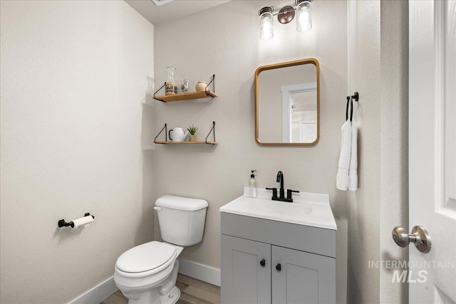 4447 W Everest St, Meridian, ID 83646 - bathroom with toilet, baseboards, wood finished floors, and vanity
