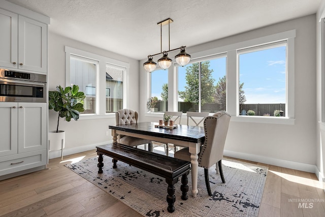 5209 W Strant Steet, Eagle, ID 83616 - dining space featuring baseboards and light wood-type flooring