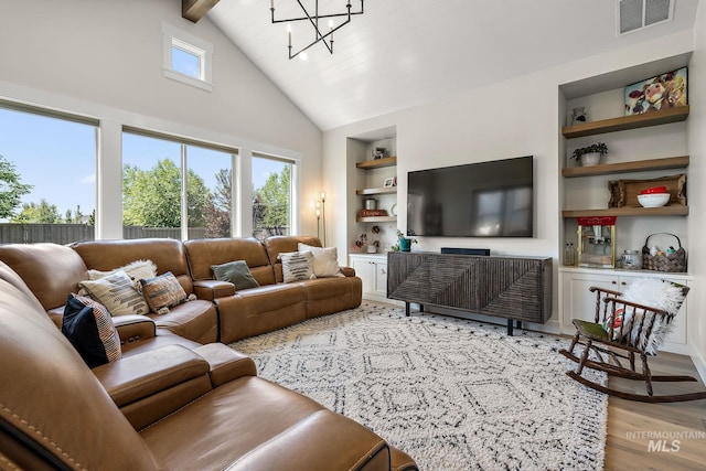5209 W Strant Steet, Eagle, ID 83616 - living area with built in features, a chandelier, wood finished floors, beamed ceiling, and high vaulted ceiling