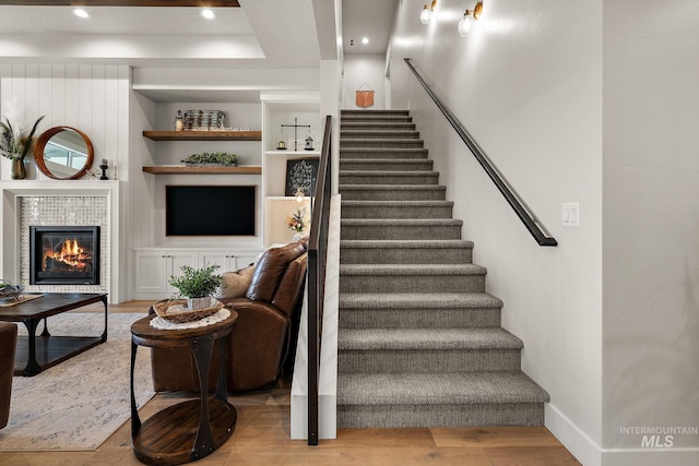 5209 W Strant Steet, Eagle, ID 83616 - staircase featuring wood finished floors, a tiled fireplace, and recessed lighting