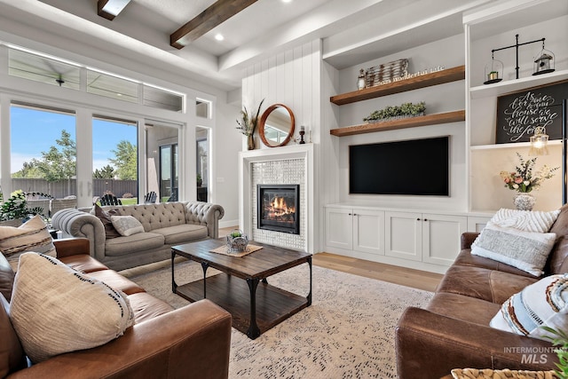 5209 W Strant Steet, Eagle, ID 83616 - living area featuring light wood-type flooring, built in features, beam ceiling, a tiled fireplace, and recessed lighting